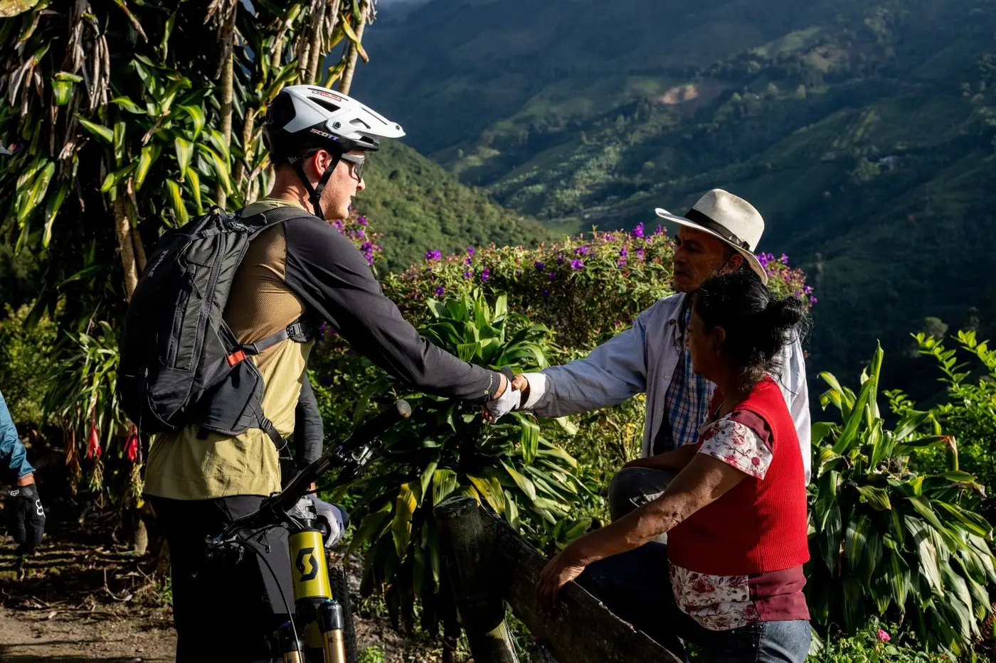 Riders greeting a local farmer on the trail