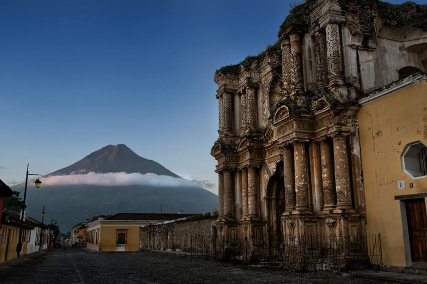 Colonial ruins in Antigua with a volcano behind