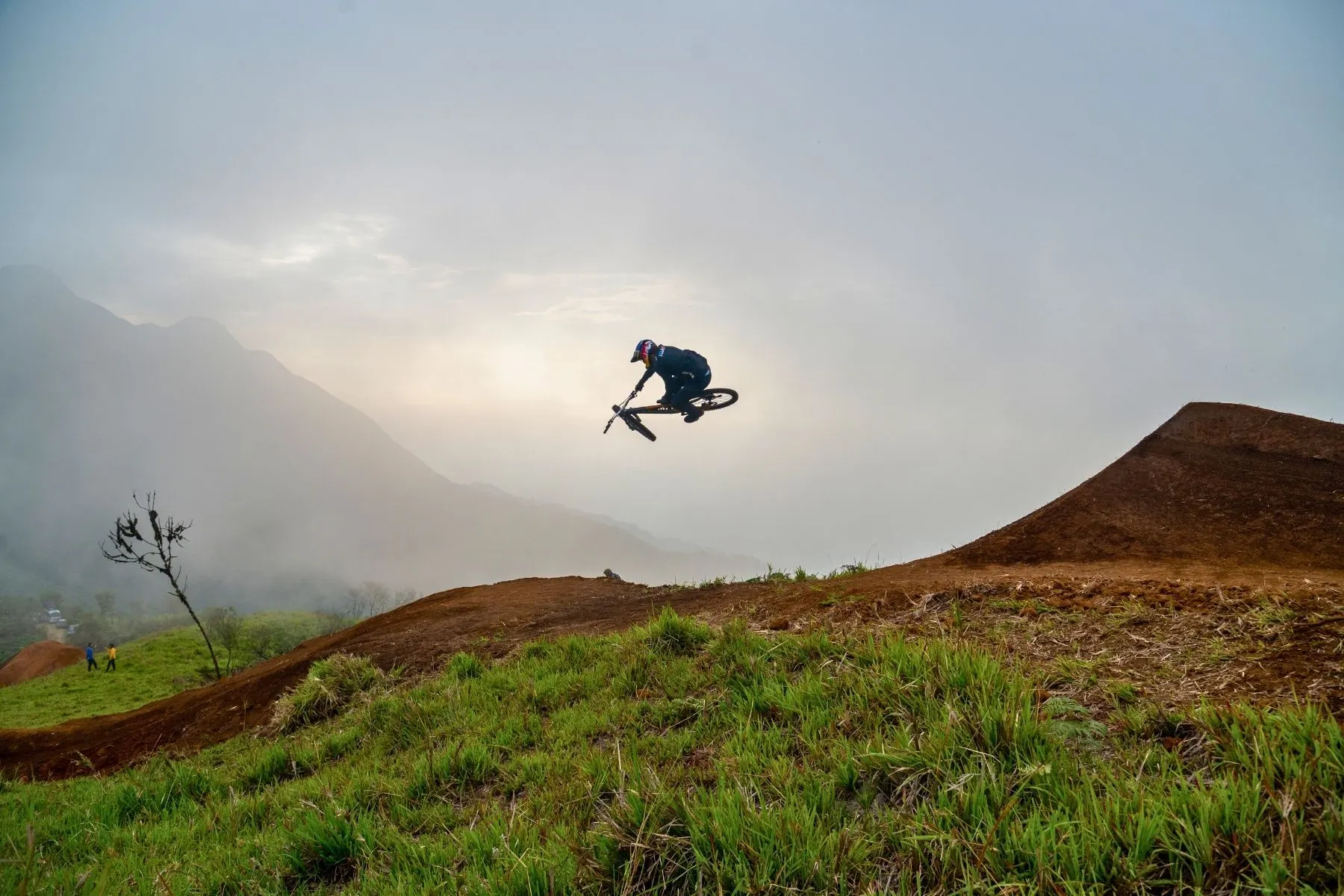Rider airborne off a volcanic lip