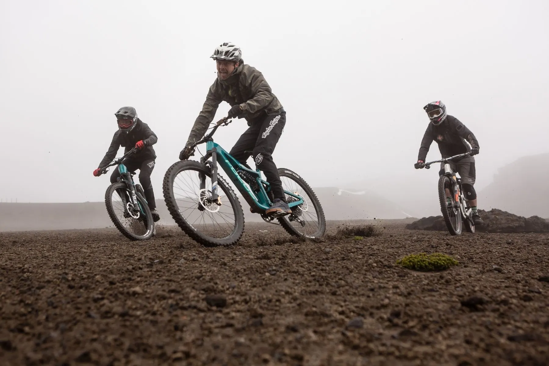 Three riders together in high-altitude mist
