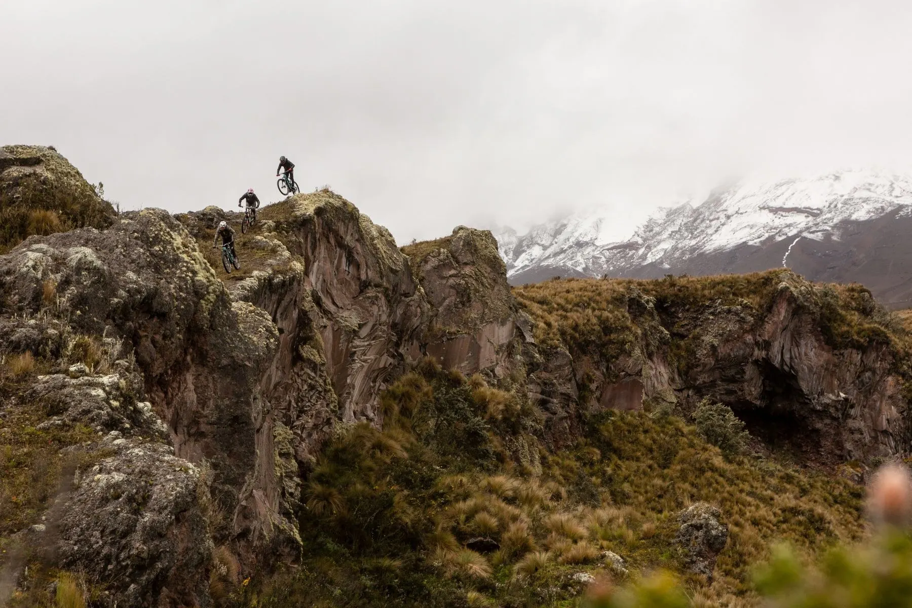 Rocky ridge trail below snow-capped peaks