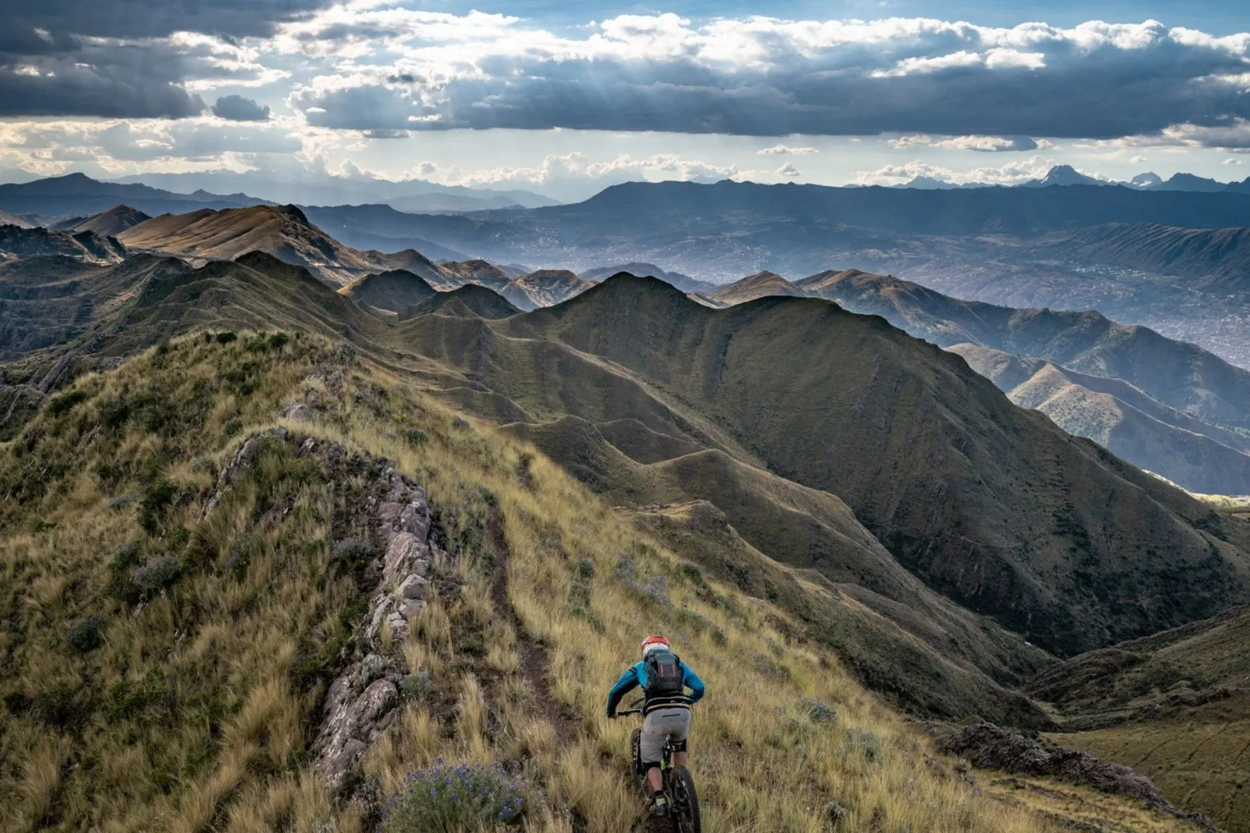 Riders on a high ridgeline above the valley