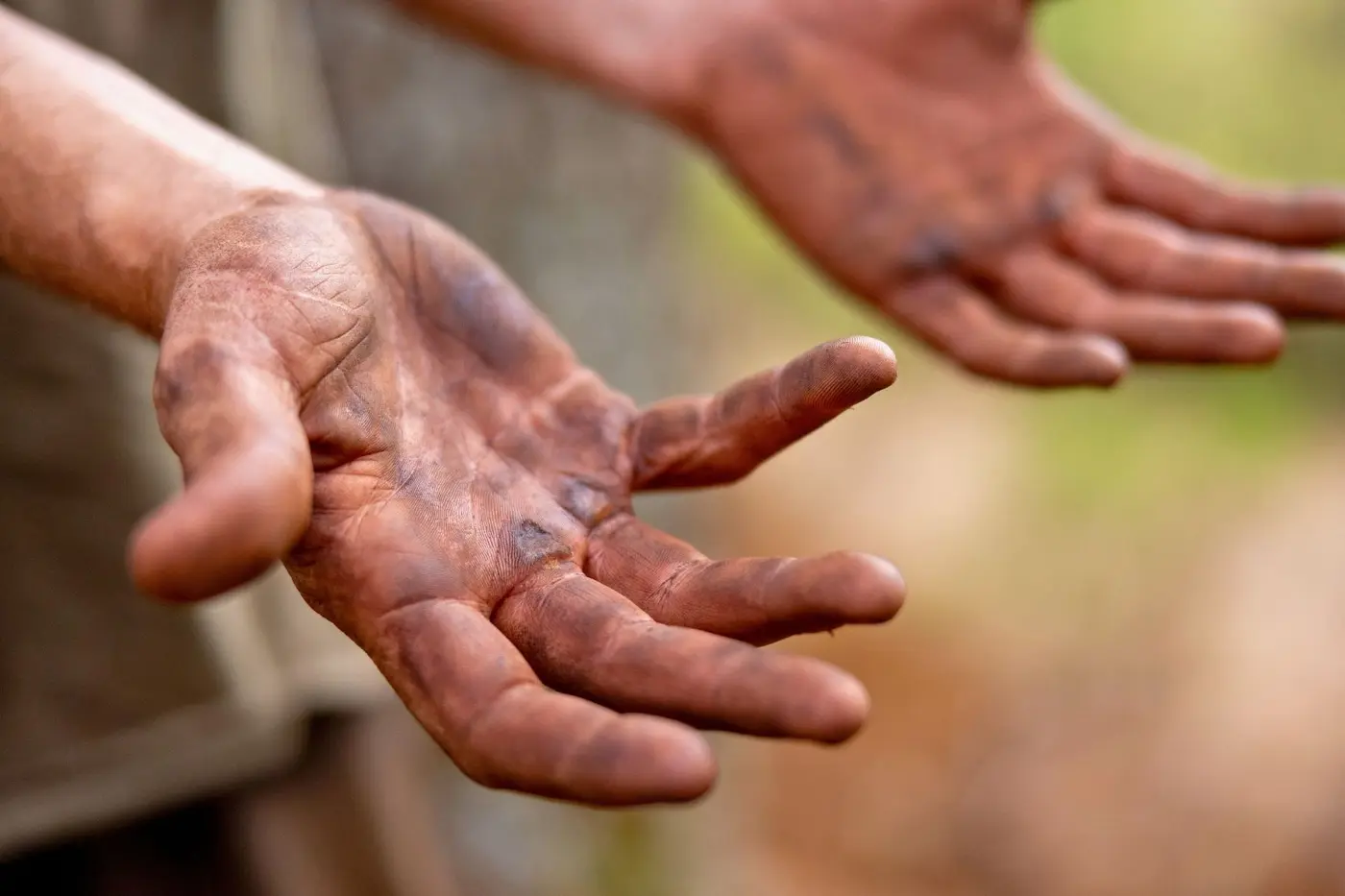 Dirt-covered hands after a day of trail building