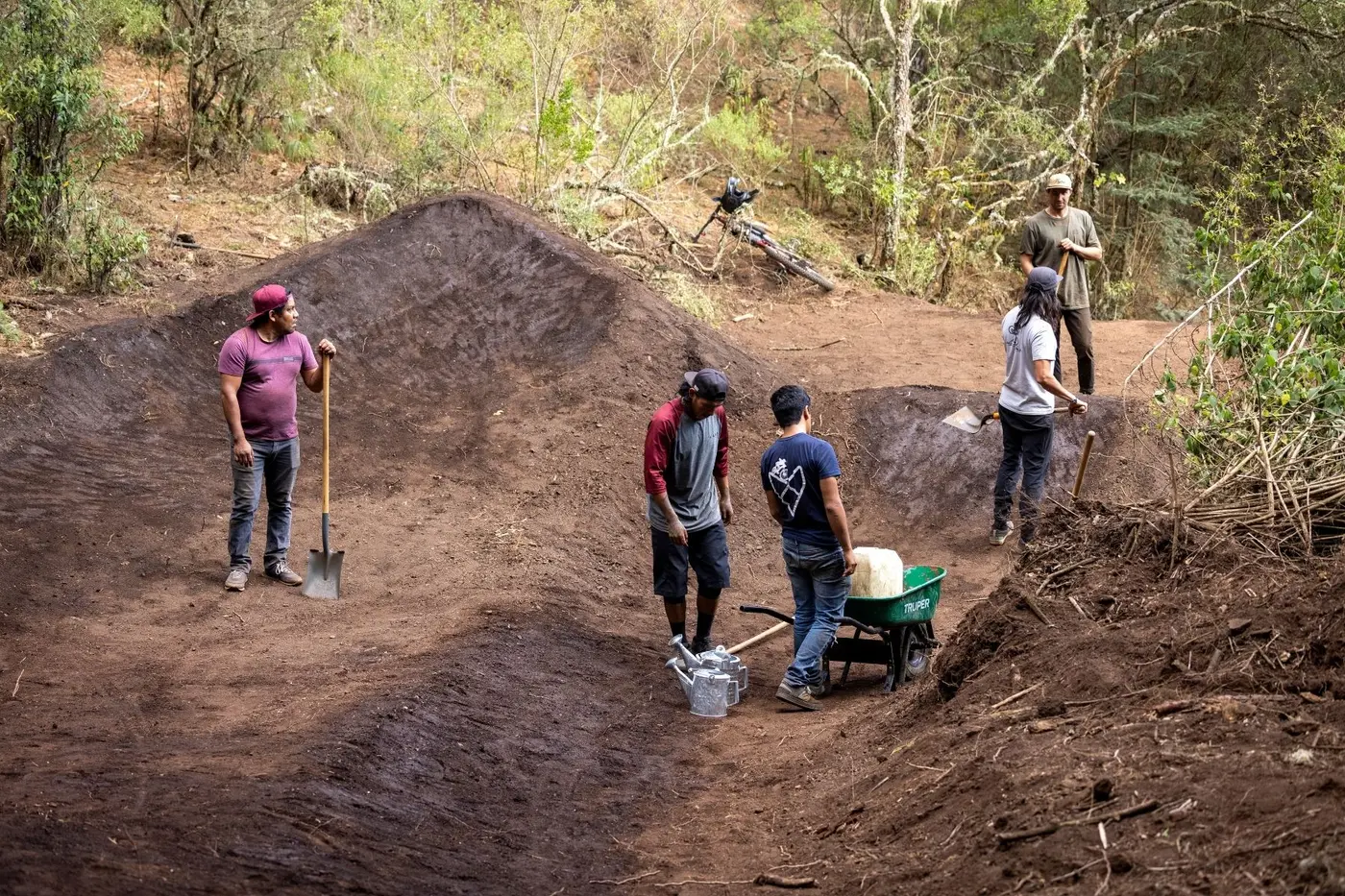 Community members building new singletrack together by hand